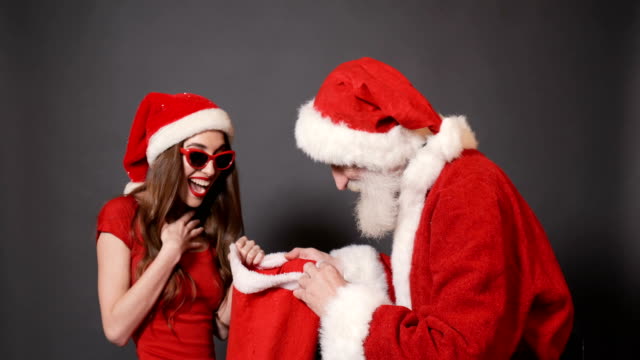 Santa-Gives-Bags-with-Presents-to-Girl