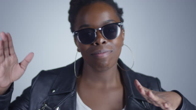 Confident-Black-Woman-in-Sunglasses-Dancing-before-Camera