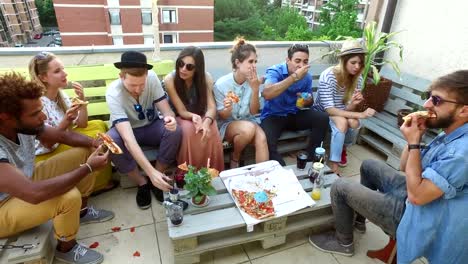 High-angle-view-of-friends-eating-pizza-on-the-rooftop-terrace