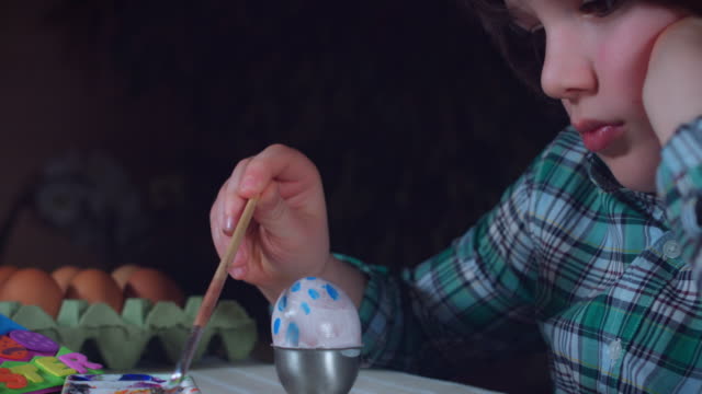 4K-Home-Shot-Of-Child-Painting-Easter-Eggs