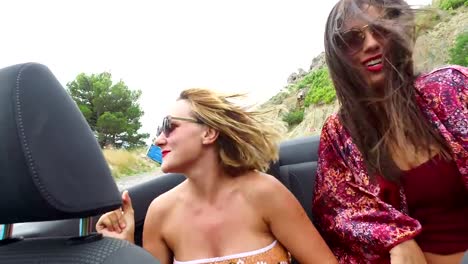 Two-happy-women-partying-in-cabriolet