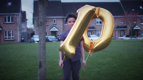 4K-Party-10-Birthday-Boy-Posing-Outdoors-with-Ballons