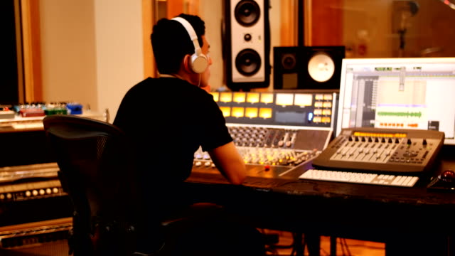 Male-audio-engineers-using-sound-mixer