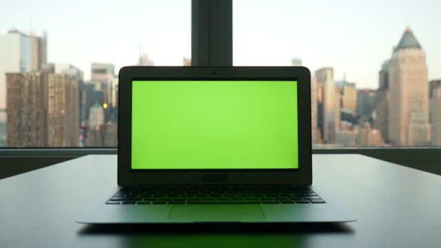 Computer-with-Greenscreen-in-Modern-Office-Building-with-Cityscape-Background.