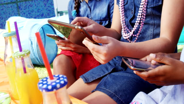 Kids-using-digital-tablet-and-mobile-phone-4k