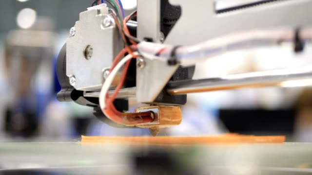 Printing-with-Plastic-Wire-Filament-on-3D-Printer.-Close-up-of-prototype-of-handcraft-3d-printer.-4K-Scientific-research-engineers-working-in-lab-with-computer-and-3D-printer