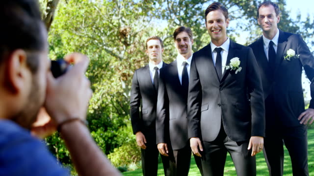 Photographer-taking-photo-of-groom-and-groomsmen-4K-4k