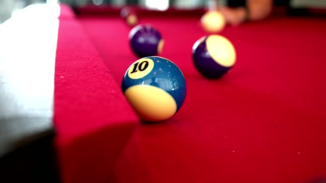 Playing-the-pool-billiard-game-on-red-baize-table.-This-is-sports
