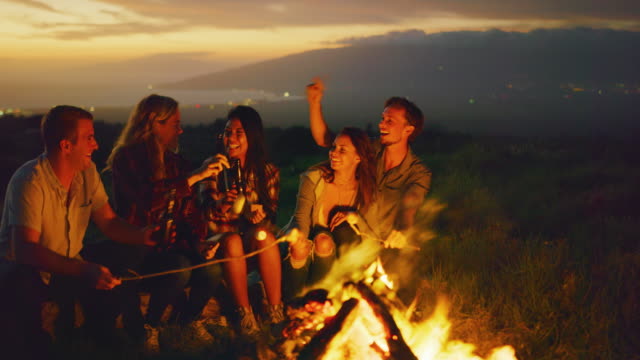 Friends-Relaxing-at-Sunset-Campfire