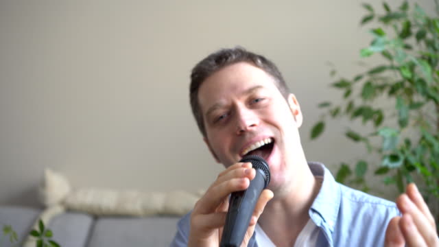 Man-singing-karaoke-at-home.-Close-up-view.