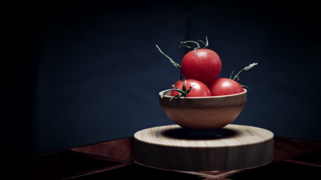 4K-Abstract-Levitation-Platform-with-Tomato-on-Black-Background
