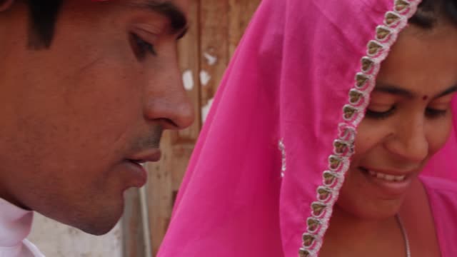 Close-up-of-Indian-couple-paying-in-currency-note-rupee-for-their-purchase-and-moving-out-for-spiritual-walk