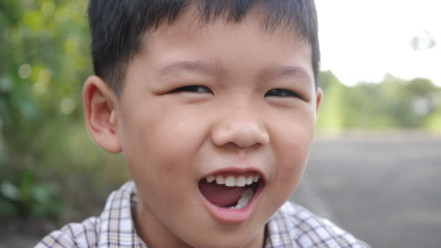 Close-up-little-boy-laughing-and-smile-after-hearing-joke-story