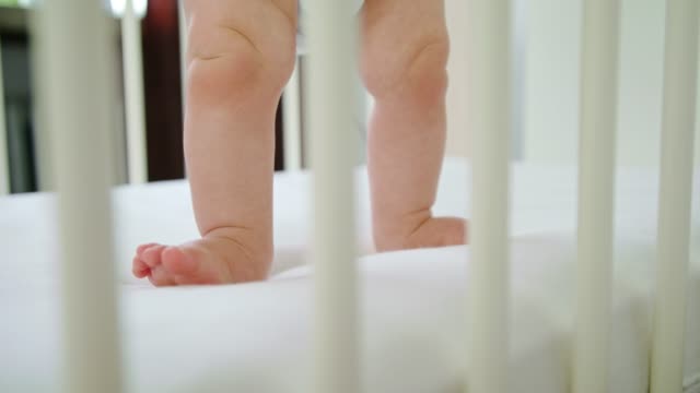 Cute-Baby-Playing-in-her-Crib-at-Home