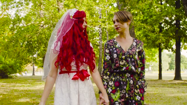 Lesbian-wedding.-The-bride-and-groom-are-walking-in-the-park