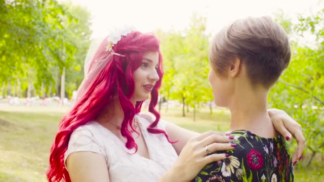 Lesbian-wedding.-The-bride-and-groom-are-hugging-each-other-and-talking