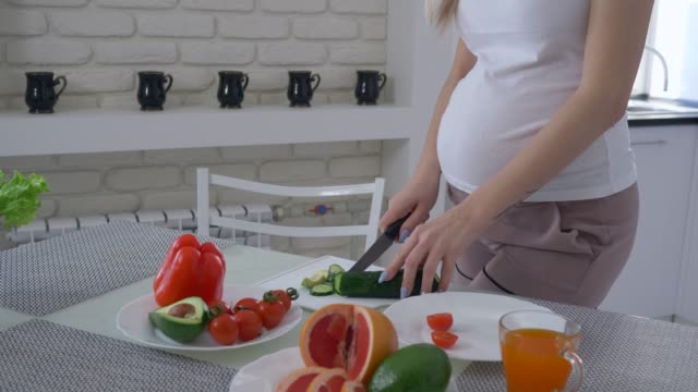 nutrición-de-mujeres-embarazadas,-mujer-expectante-con-estómago-grande-cocina-comida-útil-para-brunch-sabroso-saludable-de-verduras-frescas