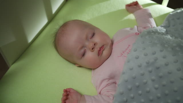 Top-Side-View-of-Sleeping-newborn-baby-dolly-shot-close-up
