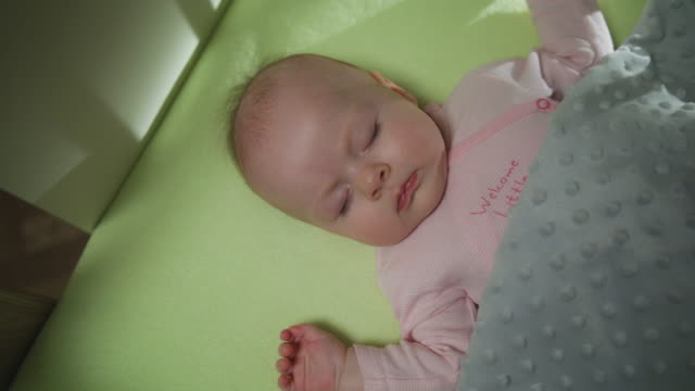 Top-View-of-Sleeping-newborn-baby-dolly-shot