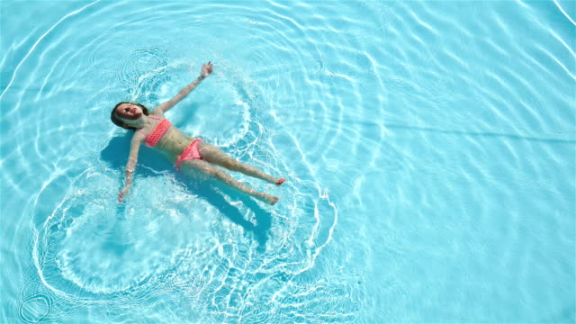 Adorable-happy-little-girl-enjoy-swimming-in-the-pool.-Family-summer-vacation,-kid-relax-at-pool.