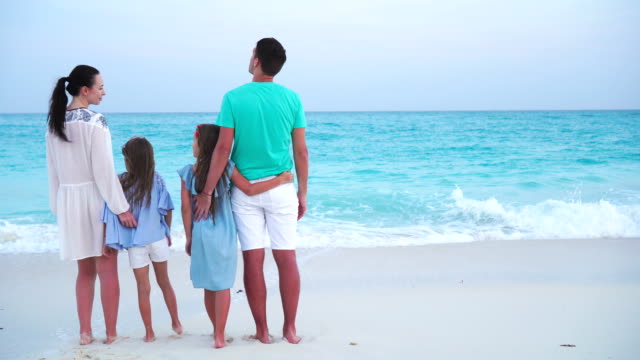 Young-family-on-vacation-on-the-beach.-Family-travel-concept