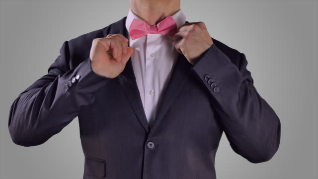 Hands-Fixing-Pink-Bow-Tie