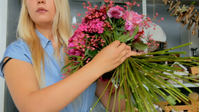 Professional-florist-making-floral-wedding-composition-at-flower-shop