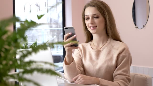 Elegant-beautiful-caucasian-woman-using-smartphone,-texting,-typing.-Smiling-60-fps