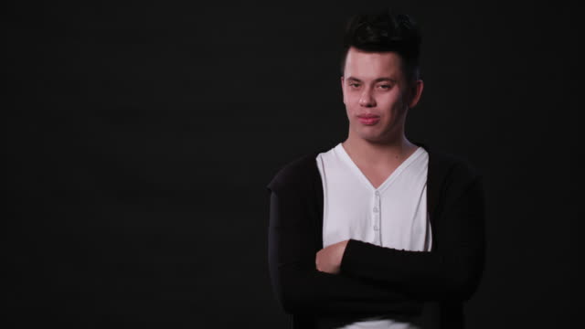 A-Young-Man-Mimicing-Against-a-Black-Background