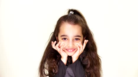 Little-cute-caucasian-girl,-smiling,-showing-an-emotion-of-expectation,-holding-her-head-with-her-hands,-portrait-white-background-50-fps
