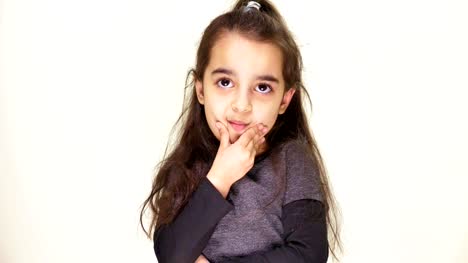 Little-cute-girl-guessing,-wondering,-thinking-and-looking-at-camera,-portrait,-white-background-50-fps