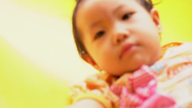 Asian-baby-girl-playing-slider-at-playground.