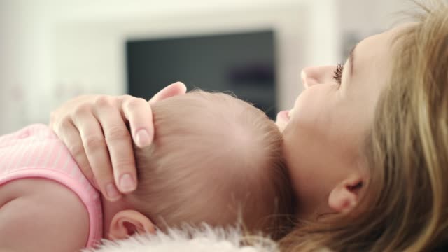 Mother-hugging-baby.-Lovely-child-sleep-in-mother-embarce
