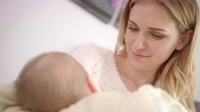 Smiling-woman-breast-feeding-baby.-Beautiful-mom-breastfeeding-child