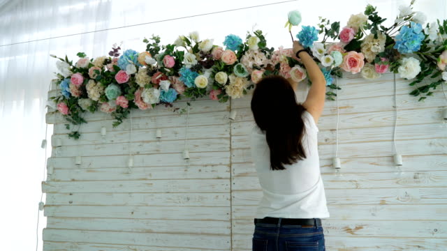 Beautiful-florist-creating-spring-colorful-bouquet-arrangement