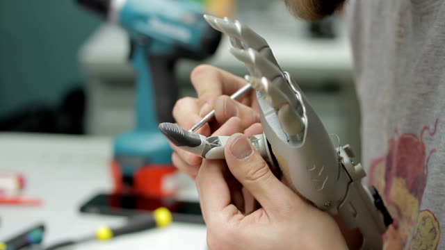 Close-up-of-artificial-hand-limb-is-being-painted