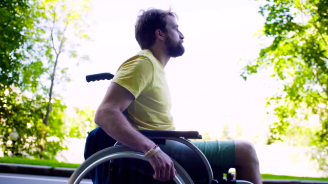 Young-disable-man-in-a-wheelchair-in-the-park