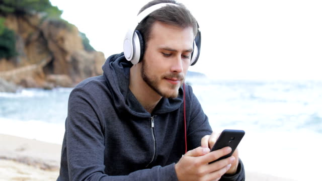 Serious-teen-downloading-and-listening-to-music
