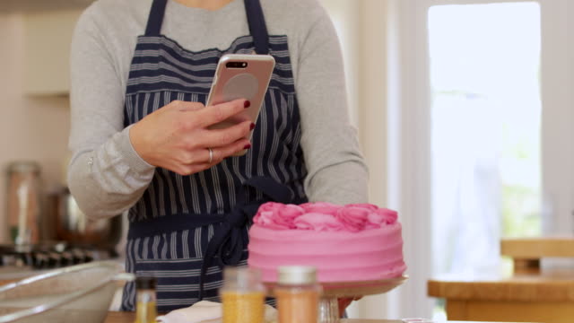 Woman-Taking-Photo-Of-Cake-She-Has-Baked-At-Home-For-Social-Media