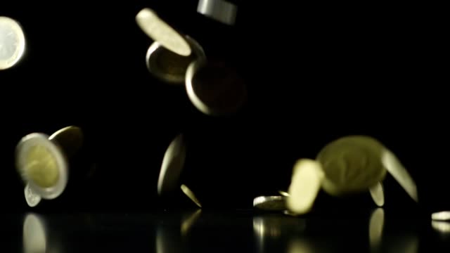 Falling-coins-slow-motion-dark-background