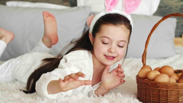 Playful-girl-putting-eggs-in-the-easter-basket