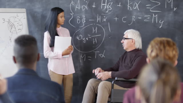 Disabled-Teacher-Discussing-Equations-with-Student