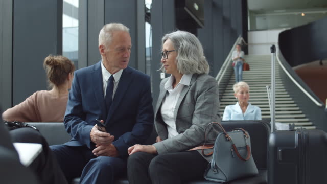 Senior-Couple-Talking-in-Airport