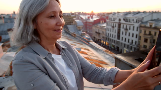 Grey-haired-Female-Tourist-on-Roof