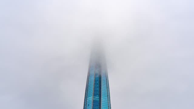 The-Spire-of-Skyscraper-in-Low-Clouds.
