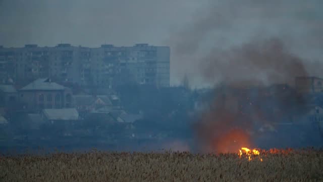 Awful-view-of-the-blazing-cane-wetland-on-the-Dnipro-riverbank-in-the-suburbs-with-rolls-of-black-smoke-in-spring