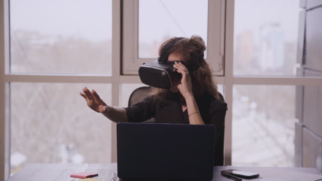 Junge-amerikanische-Frau-in-Augmented-Reality-Brille-bewegen-Hände