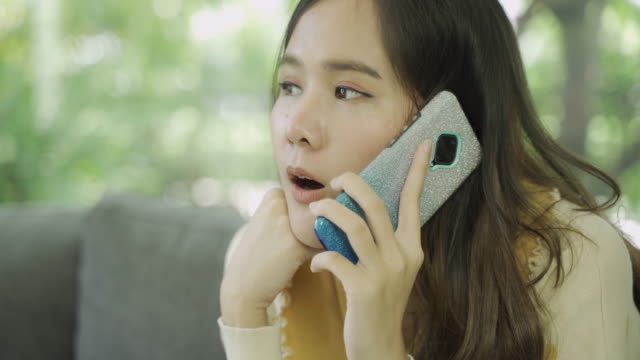 Close-up-shot-of-4K-footage-of-young-asian-woman-using-mobile-at-home.