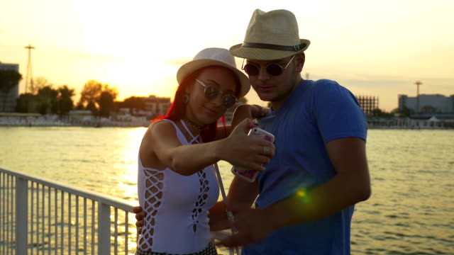 Couple-taking-selfie-at-sunset-on-a-pontoon