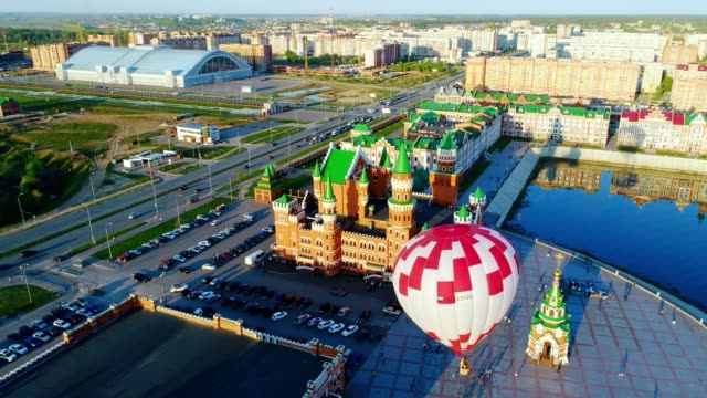 Balloon-is-rising-at-city-square.-Video,-flight-above-Yoshkar-Ola,-Russia